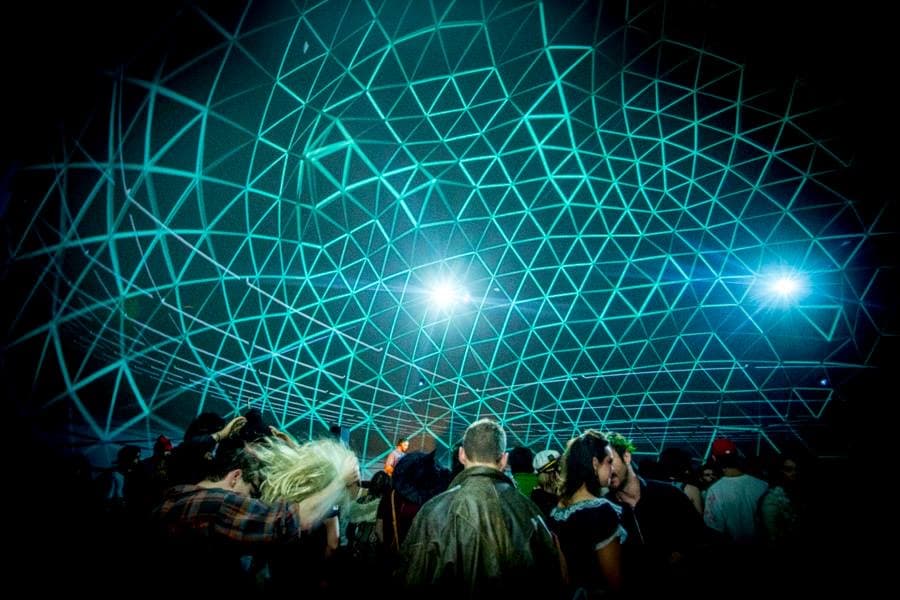 A crowd beneath a triangular grid projected on a dome